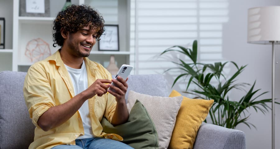 Homeowner navigating a home security app on his cell phone